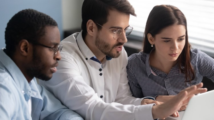 Image of 3 people looking at a computer