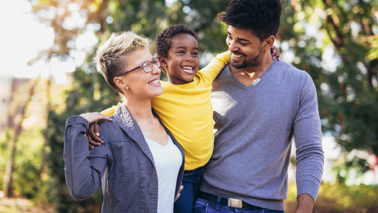 image of a couple holding a child