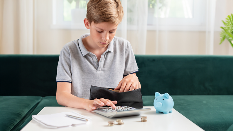 Photo of teen boy counting money and piggy bank