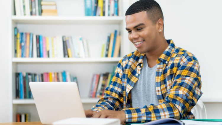 Photo of a person sitting at their laptop