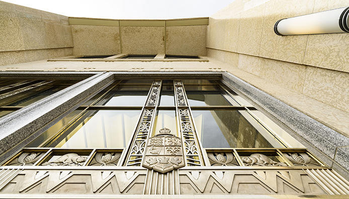 Photo of the Detail of Coat of Arms of Canada over east entrance.