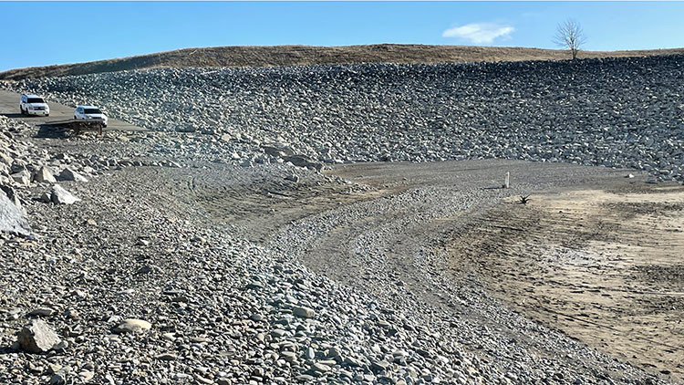 Oldman provincial recreation area boat launch - rocky and sandy area with vehicles in the background