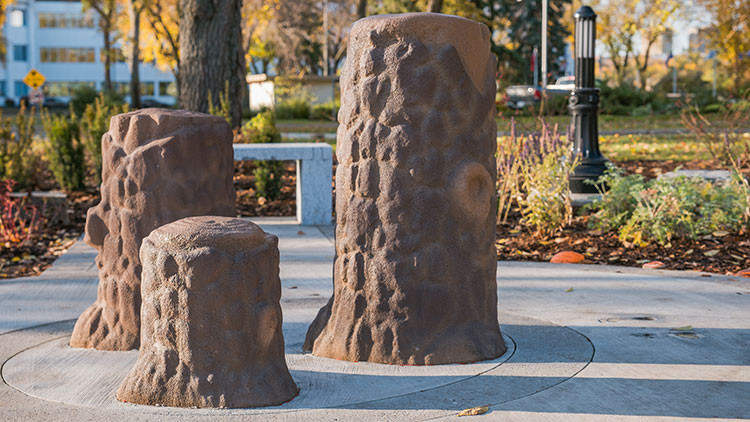 Alberta reconciliation garden offering logs (3 vertical logs in different sizes))