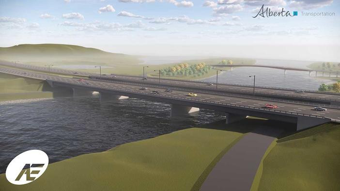 Looking southeast at the twinned bridge over the Bow River with pedestrian bridge in background.