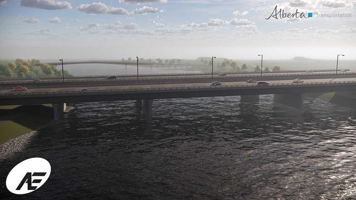 Looking south at the twinned bridge over the Bow River with pedestrian bridge in background.