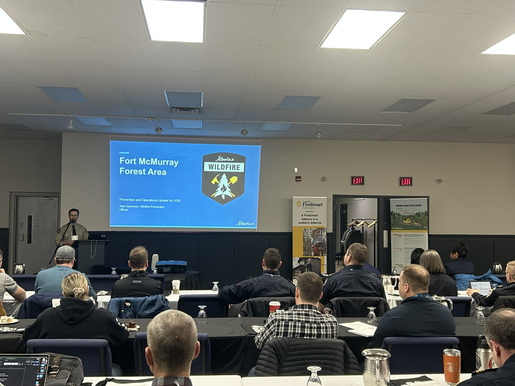 A Forestry representative shows a presentation to a group of people about the upcoming fire season.