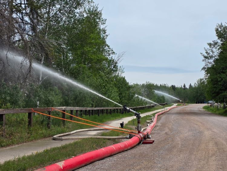 Successful test of high-volume sprinkler system at slide zone walkway near Fort Smith, June 9, 2025.