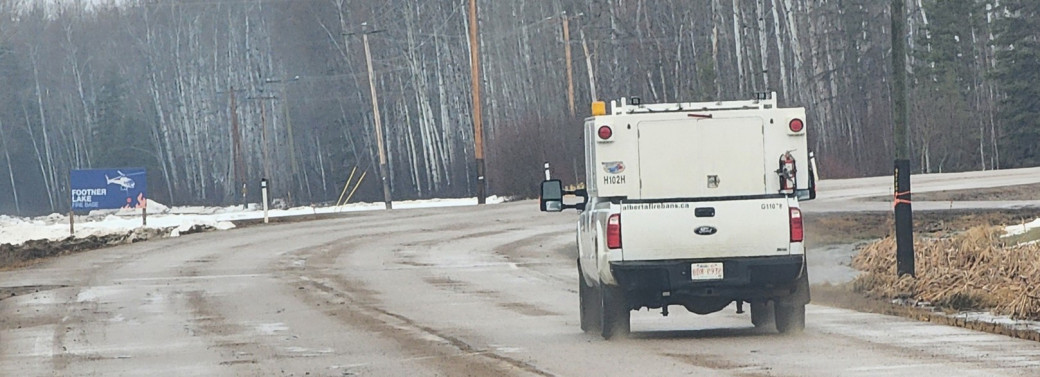 Wildfire truck drives on road near Footner fire base