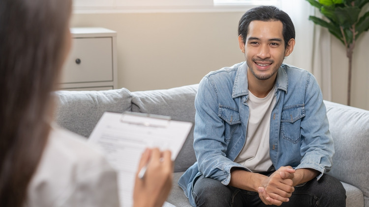 A smiling patient talking to a counsellor