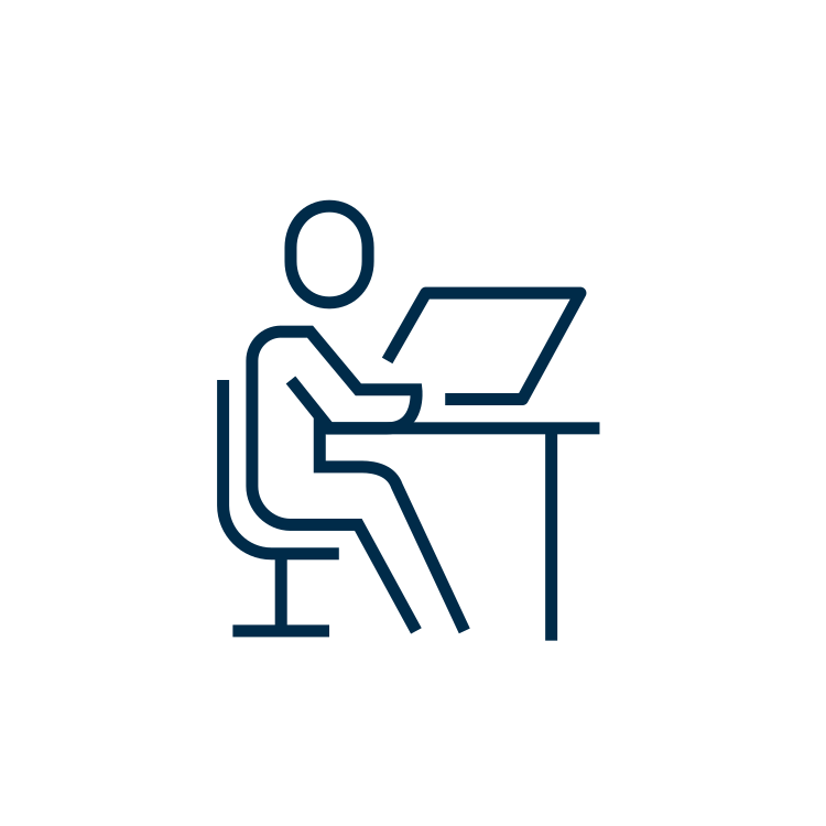 Icon of a person sitting at a desk, using a computer
