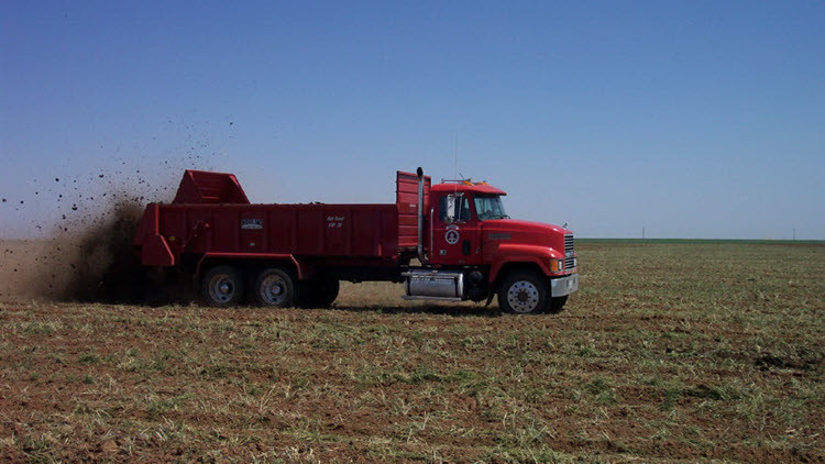 Photo of a truck spreading manure