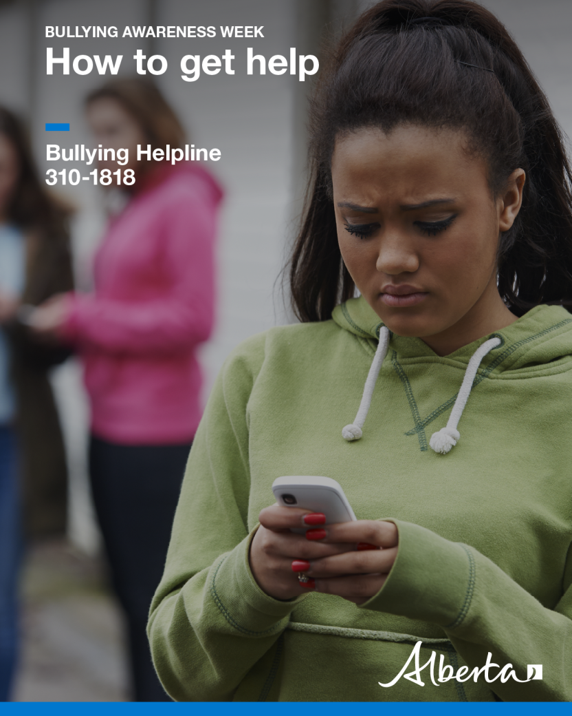 Image of a young woman looking down at her cell phone with a look of concern on her face.