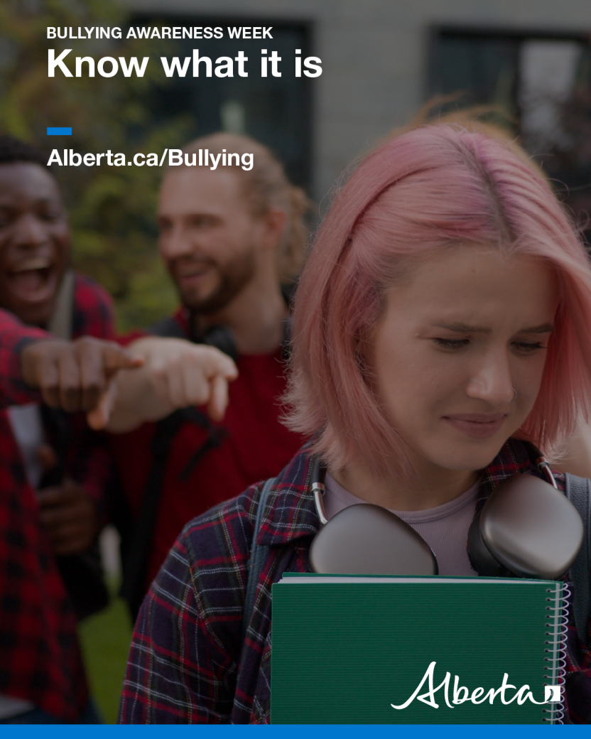 Image of a girl with pink hair and a sad expression walking past two men who are pointing at her and laughing.