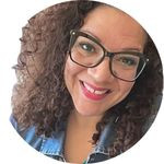 Christie Pace wears glasses and smiles while tilting her head to the left.