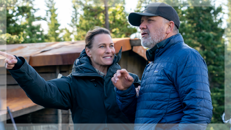 Woman pointing finger next to a man wearing a ball cap and blue jacket