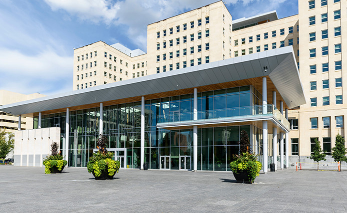 The Edmonton Federal Building with fountains and crowds in front of it.