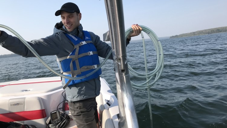 Bradley Peter, Executive Director at the Alberta Lake Management Society, collecting a water sample from Ethel Lake in east Alberta (photo: Alberta Lake Management Society).