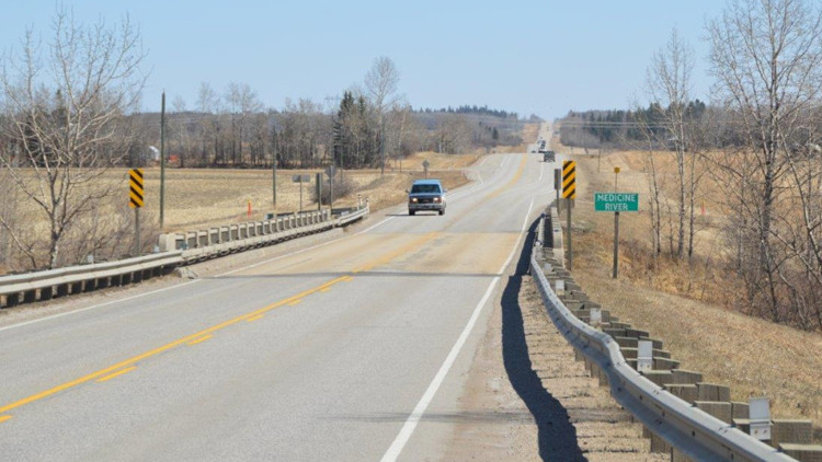 Single lane highway near Medicine River looking east.