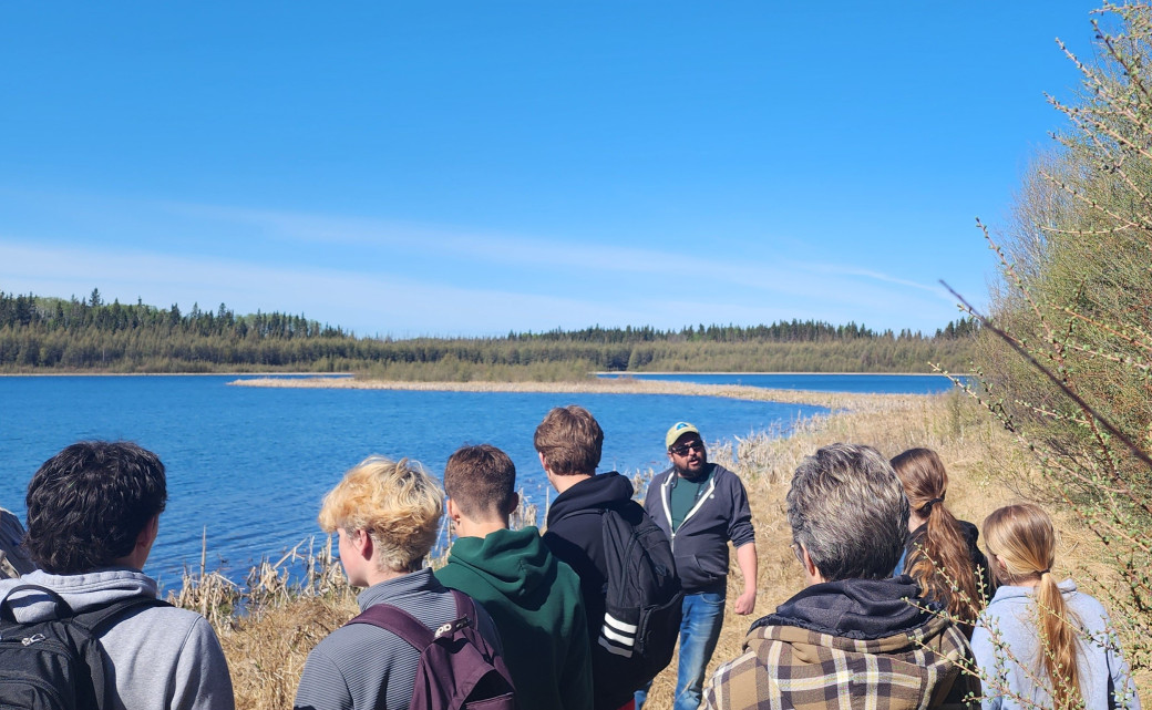 Forestry educator speaks with students at Machesis Lake on May 15, 2025
