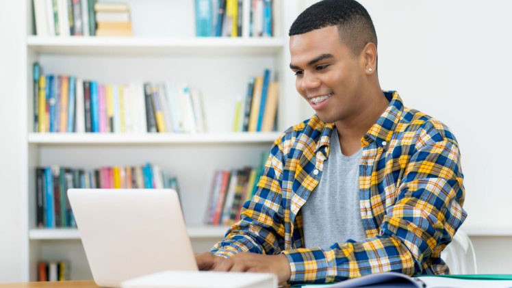 Photo of a person sitting at their laptop