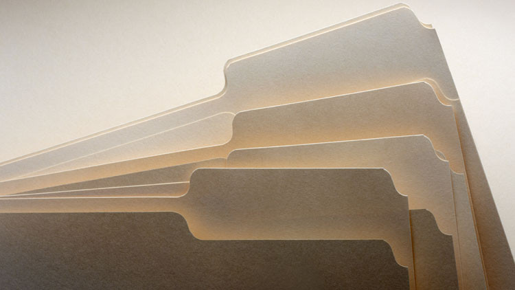 A stack of blank manila folders.