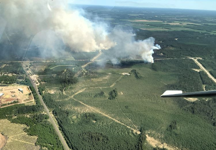 Smoke over the forest and roads.