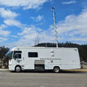 Mobile Air Monitoring Laboratory - a white, 8-metre-long retrofitted RV parked on the side of a street