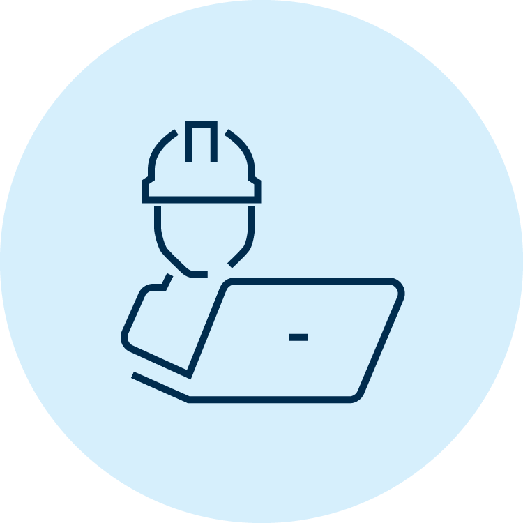 Worker in a hard hat using a laptop computer