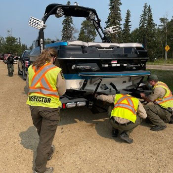 Watercraft being inspected for aquatic invasive species contamination at the Mulhurst Bay Inspection Station at Pigeon Lake, Alberta.