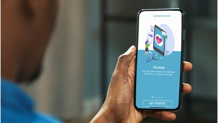 photo of a man holding a mobile phone with application