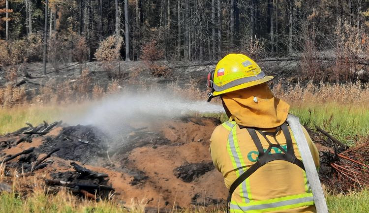 Firefighter extinguishing hotspots SWF089