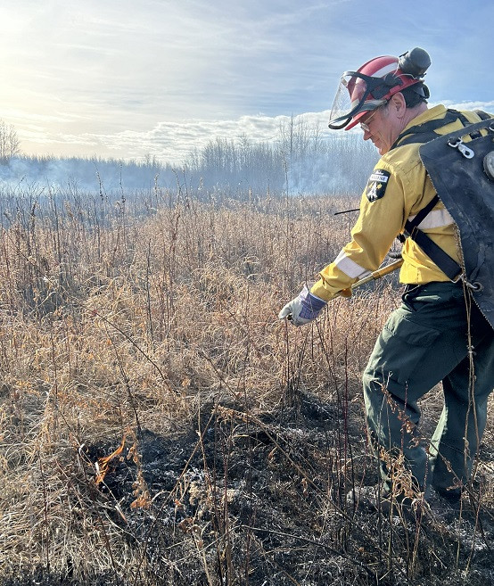 Firefighter extinguishing hotspots