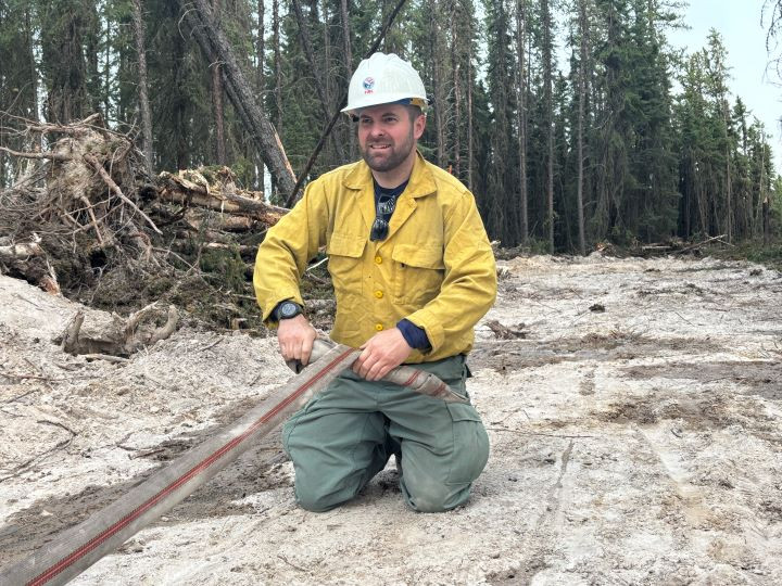 Out of country fire fighters rolling up line to move to the next spot