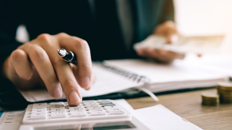 Photo of a hand using a calculator