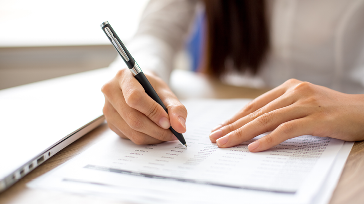 Photo of a woman with a financial report 